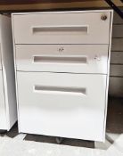 Pair of three steel three-drawer white-finish filing cabinets on castors (with keys), 57cm high x