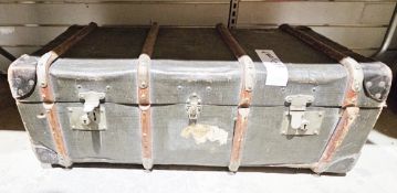 Early 20th century canvas covered and wooden bound travelling trunk with leather handles and the