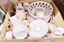 Collection of early 20th century pink ground tea and dinnerware, some with gilded handles, including