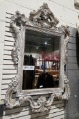 Large modern wall mirror, the rococo-style wooden frame with a limed effect finish, the plate with