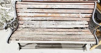 Garden bench with wooded slatted curved back and seat and metal arms, 70cm high x 126cm wide x