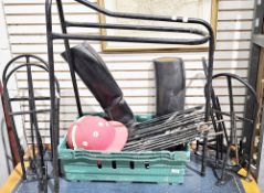 Collection of equestrian horse riding items including five saddle racks, a pair of riding boots, a
