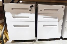 Pair of three steel three-drawer white-finish filing cabinets on castors (one with key), 57cm high x