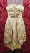 A 1950's satin brocade yellow cocktail dress, strapless, with a matching belt and bow detail, panels