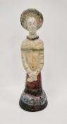 Shelagh Spear raku figure of a standing woman, with headdress and arms crossed, on a domed base,