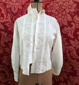 An Edwardian embroidered blouse with mandarin collar, slight leg o mutton sleeves embroidered at the