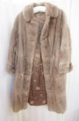A full length vintage fur coat with half belt detail at back