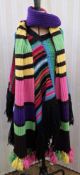 A hand crochet poncho, multiple colours with very deep black fringe, and a hand knitted 'Dr Who'