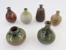 Six various studio pottery bottle-shaped vases in various shades of green, brown and beige (6)