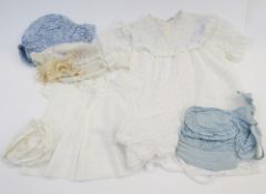 An Edwardian baby's bonnet, with lace and ribbon detail, another Edwardian bonnet, a blue striped