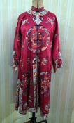 A Chinese  embroidered robe, possibly mid-century, red silk embroidered with Chinese female