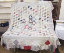 A large patchwork bedspread, early 20th century, with lozenges, hexagonals, squares etc. measuring