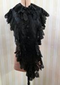 A black Victorian shawl/cape, with figured satin panels, faux jet beaded embellishment with a