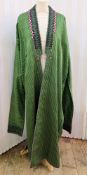A green gold striped cotton kaftan with very long sleeves, embroidered detail in wool to the facings