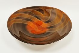 Large Svaja centrepiece glass bowl/charger, decorated with orange stripes on brown ground, signed to