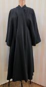 A mid century black duster evening coat, unlabelled, the lining has moth damage and there is moth