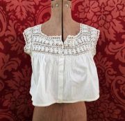A short Victorian blouse with part lace bodice and sleeves, pintucked and front button fastening,