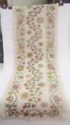 Embroidered suzani panel on a cream linen ground, central foliate scrolling design, embroidered