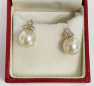 Pair of gold, diamond and pearl stud earrings, the cultured pearls (9.86mm diameter approx)