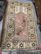 Large salmon ground rug with geometric motif and floral design, multiple geometric and floral