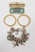 Silver curb link charm bracelet with textured clasp hung with numerous silver charms, a pair of gilt