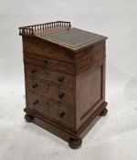 In the manner of Gillows of Lancaster a William IV burr walnut davenport, the sliding top with