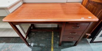 Mid-century teak office desk having a single pedestal with pull-out pen slide tray over three