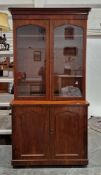 Victorian mahogany library bookcase cupboard, the upper section with two arched glazed doors opening