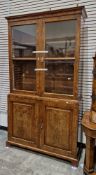 Early 19th century burr walnut and crossbanded library bookcase cupboard, the moulded cornice over