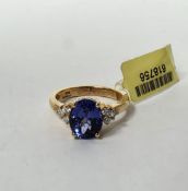 18k yellow gold, tanzanite and diamond ring, claw set with an oval mixed cut tanzanite (approx. 10.