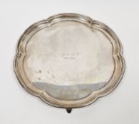 Silver salver by Atkins Brothers, Sheffield 1933, of shaped circular form with moulded rim, on three