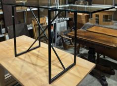 Contemporary Conran console table with glass top on a black tubular metal stand. Height 72cm, length