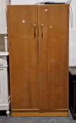Mid-century E Gomme for G-Plan an oak Brandon double wardrobe, the two doors with oak loop handles