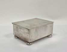 Silver box by Tiffany & Co, of plain rectangular form with hinged cover, on four bun feet, the