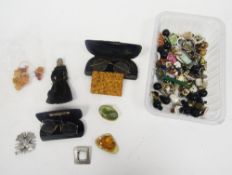Collection of costume jewellery and other items including faux amber beads, brooches, earrings,