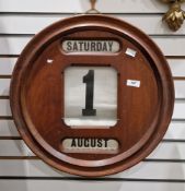 Edwardian mahogany circular wall perpetual calendar, the three apertures holding canvas days,