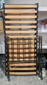 Pair of Victorian-style grey metal single bedsteads with brass-effect knobs, wooden slatted bases,