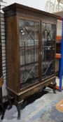 Early 20th century mahogany glazed bookcase, the cornice with dentil moulding and foliate scrolled