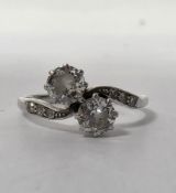 Platinum and diamond cross-over ring, the two claw-set round old cut diamonds of approx. 4.5mm