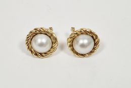 Pair of 18ct gold and cultured pearl stud earrings, the pearl set within ropetwist borders, 8.6g