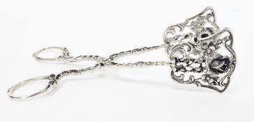Pair of 835 standard silver tongs, the terminals pierced with rose decoration, 15cm long (1)