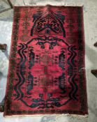 Eastern red ground rug with geometric and floral design field, single geometric border, 130cm x 85cm