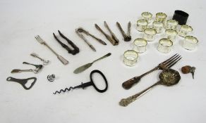 Set of 12 silver plated napkin rings of plain circular form, assorted silver plated nutcrackers