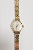 Lady's Omega 9ct gold bracelet watch, the circular dial with baton and numeral markers, on brick-