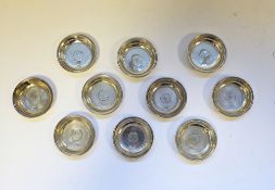 Set of ten Turkish silver small dishes, each of circular form and set with a Turkish silver coin,