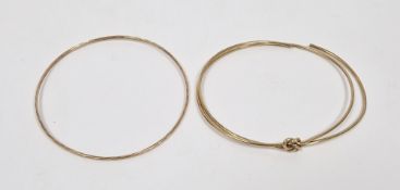 9ct gold bangle designed as two wires with intertwined knot (one wire cut) and another gold-coloured