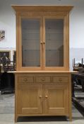 M&S Home Light pale oak display cabinet having two glazed doors opening to two glass shelves, over