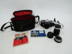 Canon reflex FTQL camera, no. 125836 together with a Canon Hanimex tele-lens no.H67689, with two