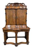 Mid 18th century South German walnut and parquetry cabinet on stand, of serpentine form, the domed