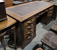 Large Art Deco oak twin-pedestal desk, the rectangular top with brown leather inset writing surface,